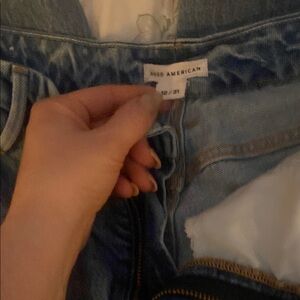 Good American Blue Jeans with Distressed Style and Straight Leg ankle cut